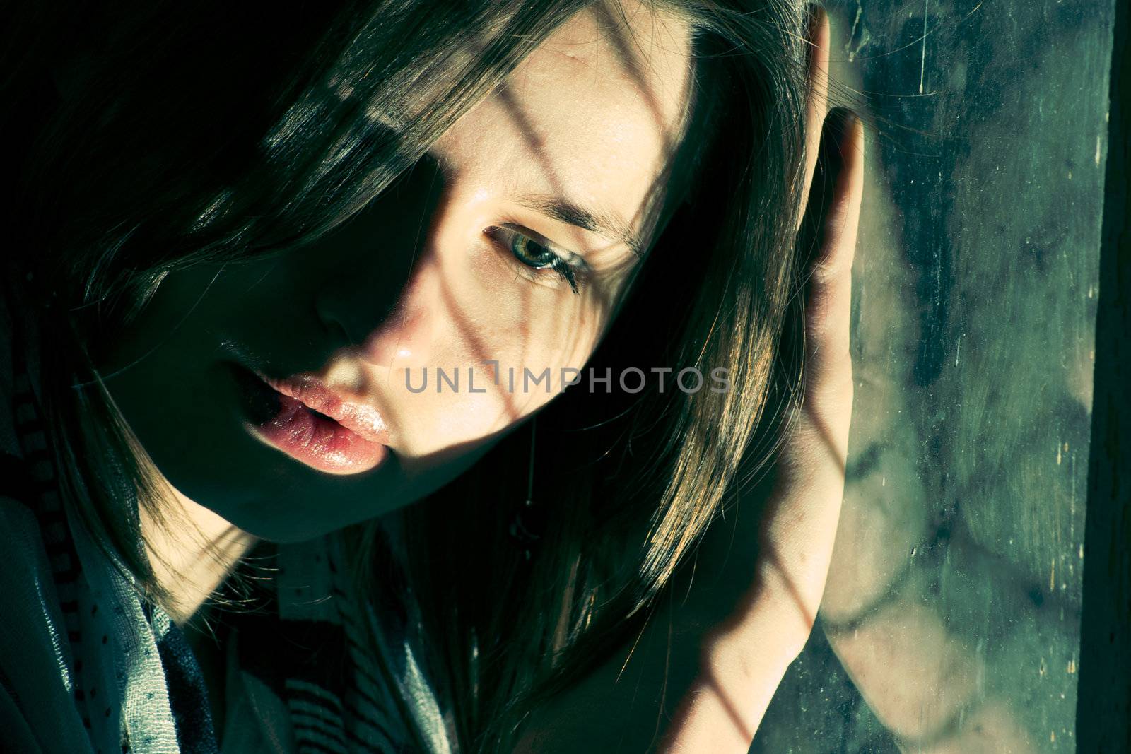 Young scared girl  in old abandoned house.