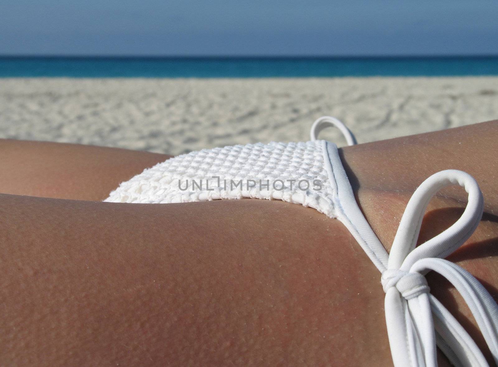 female in a white bikini on the beach