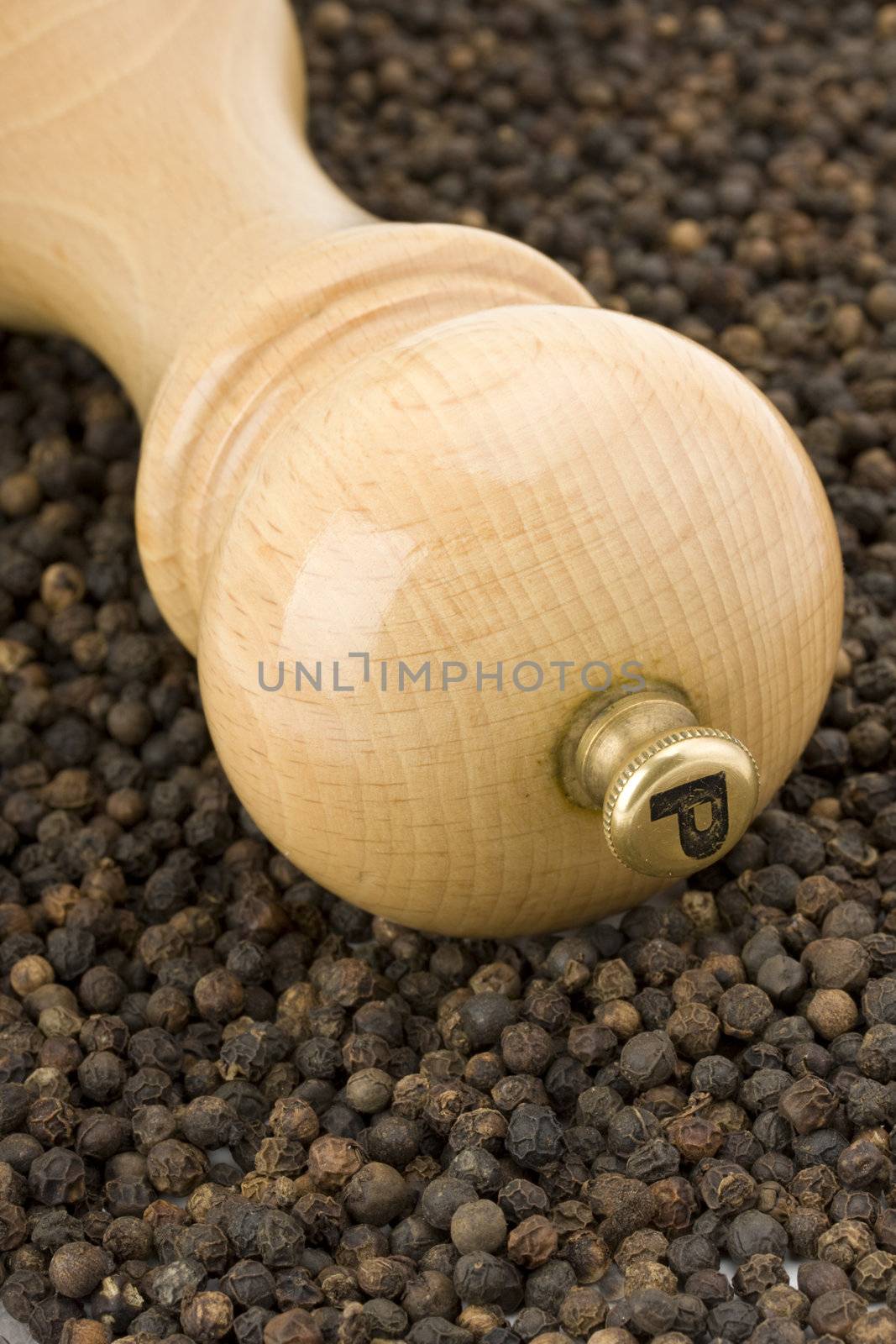 a wooden pepper mill on white background by bernjuer
