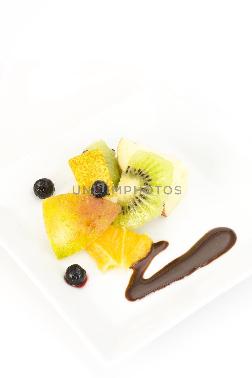 fruit salad composed of kiwi, orange, apple, lime and lemon slices