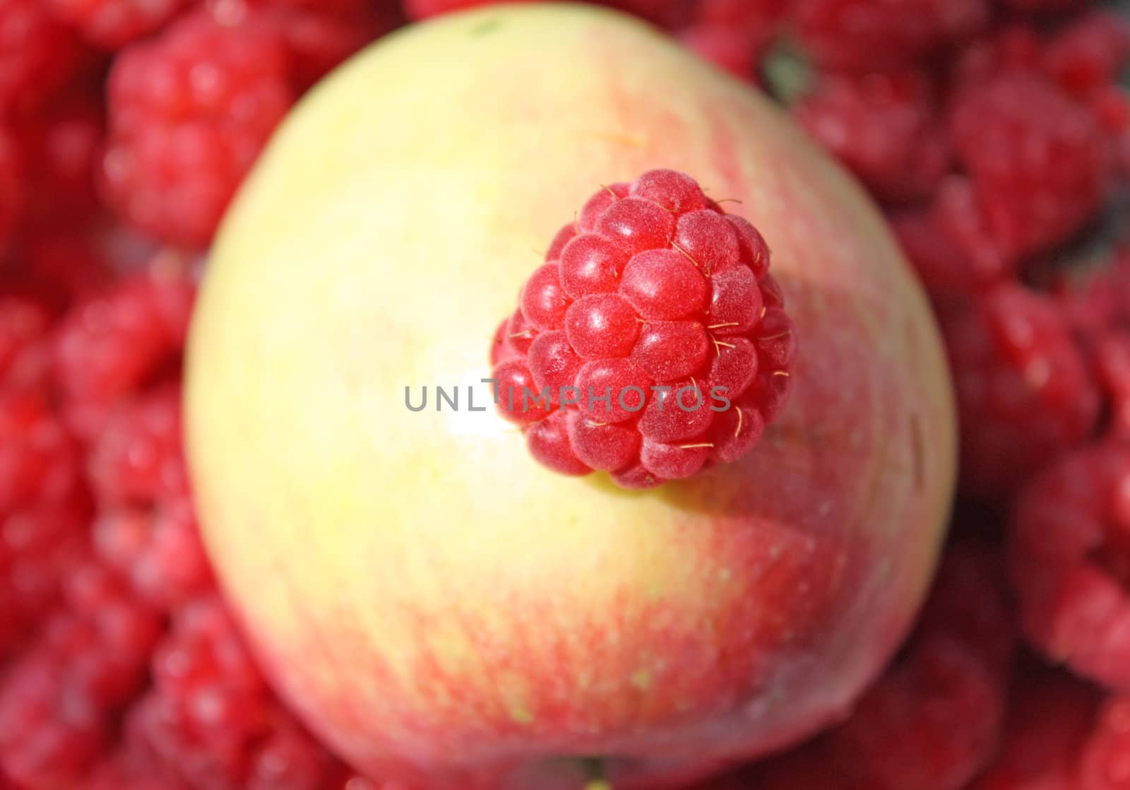 Close up of the juicy raspberry on the apple. 