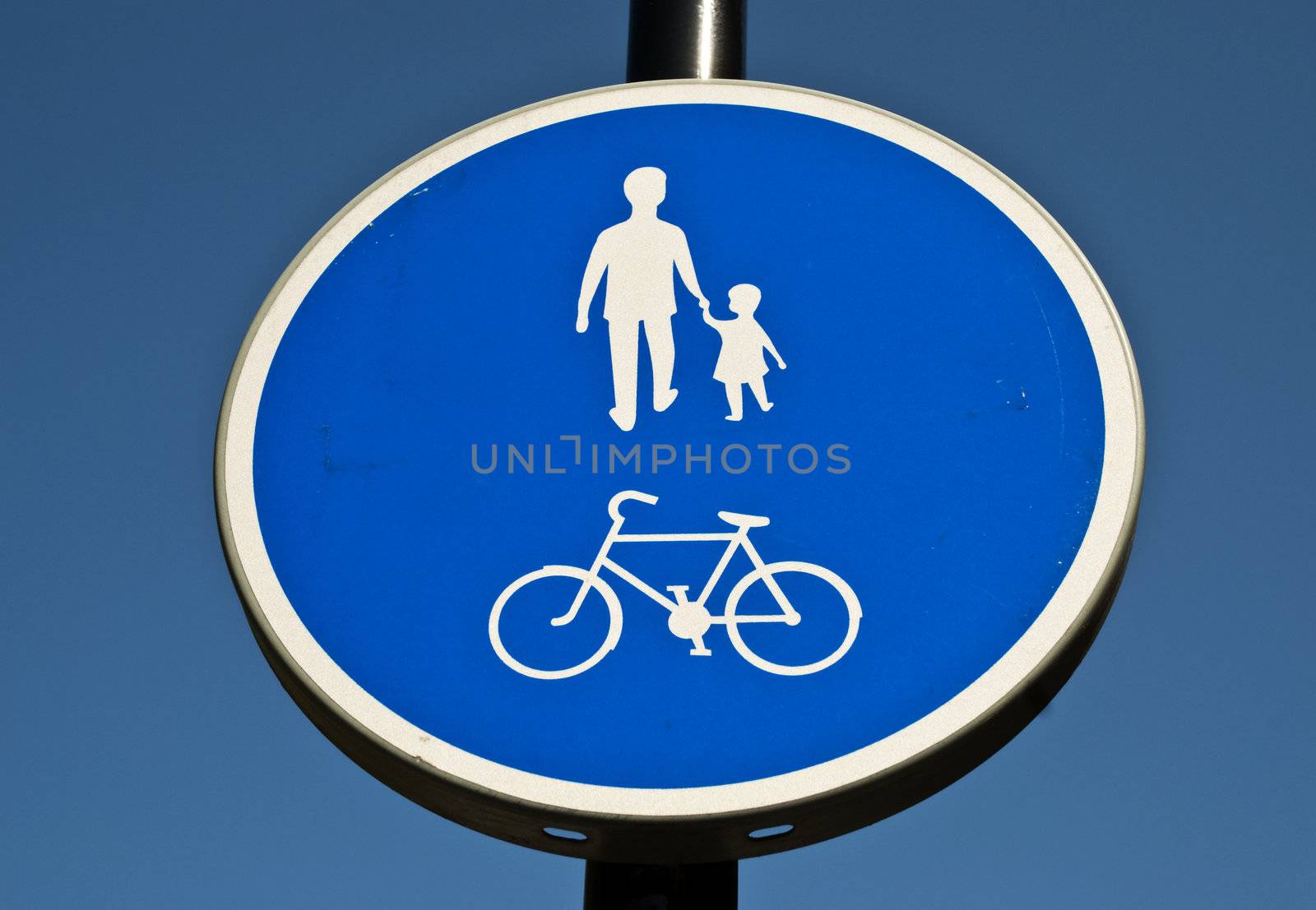 A close up of a blue and white walking and cycling sign