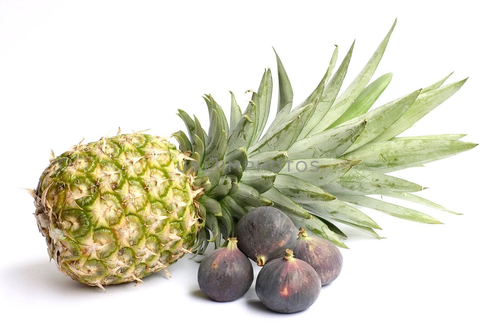 Fresh ananas and figs isolated on white background. 