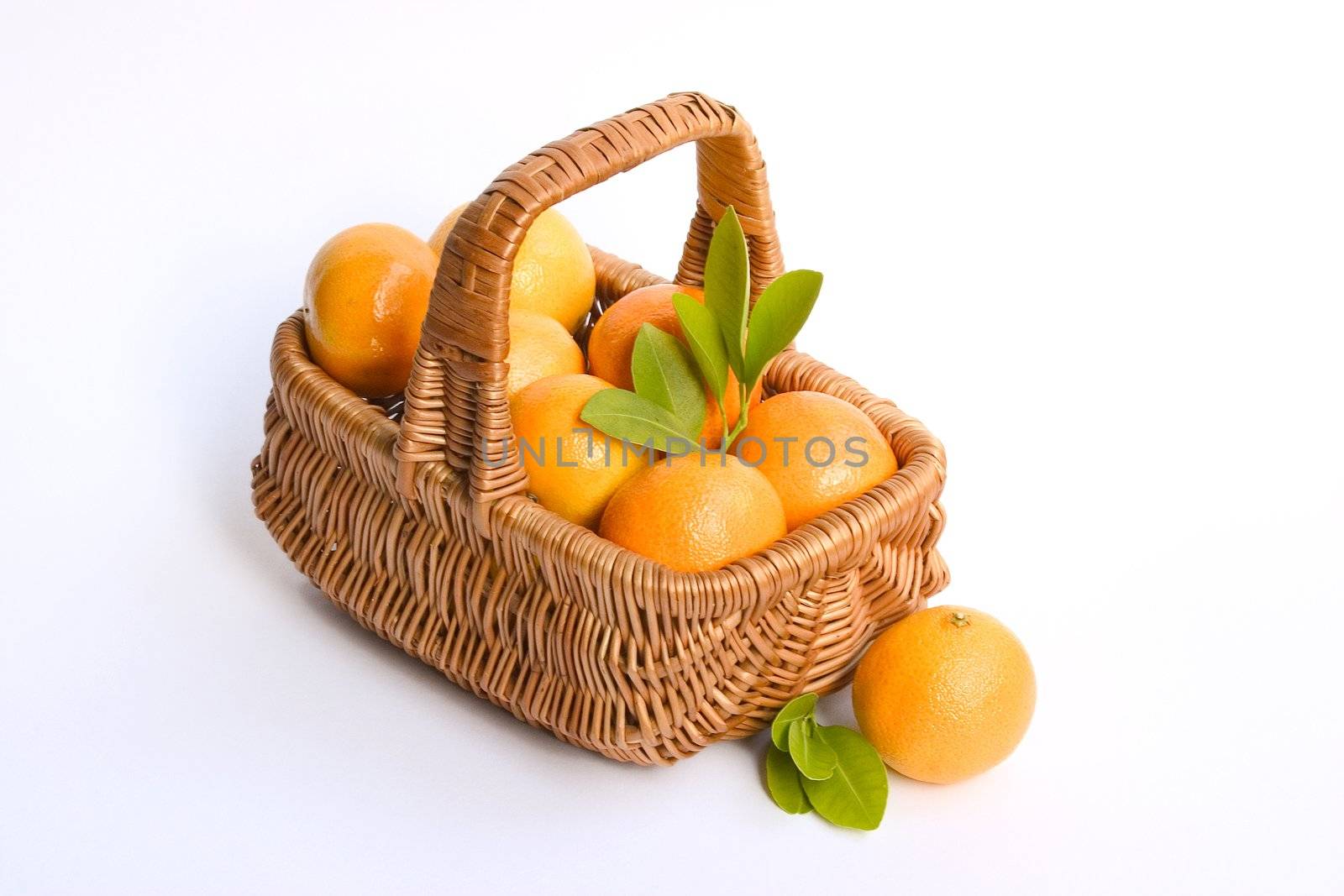 Basket with clementines isolated on white background