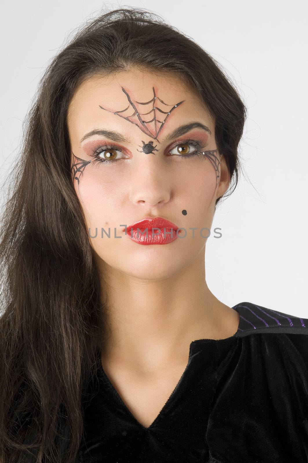 young and nice brunette with spider web painted on face