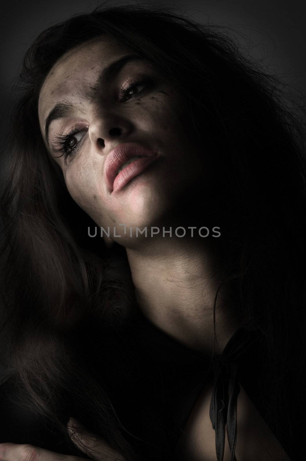 brunette in panic with broken make up in a desaturated portrait
