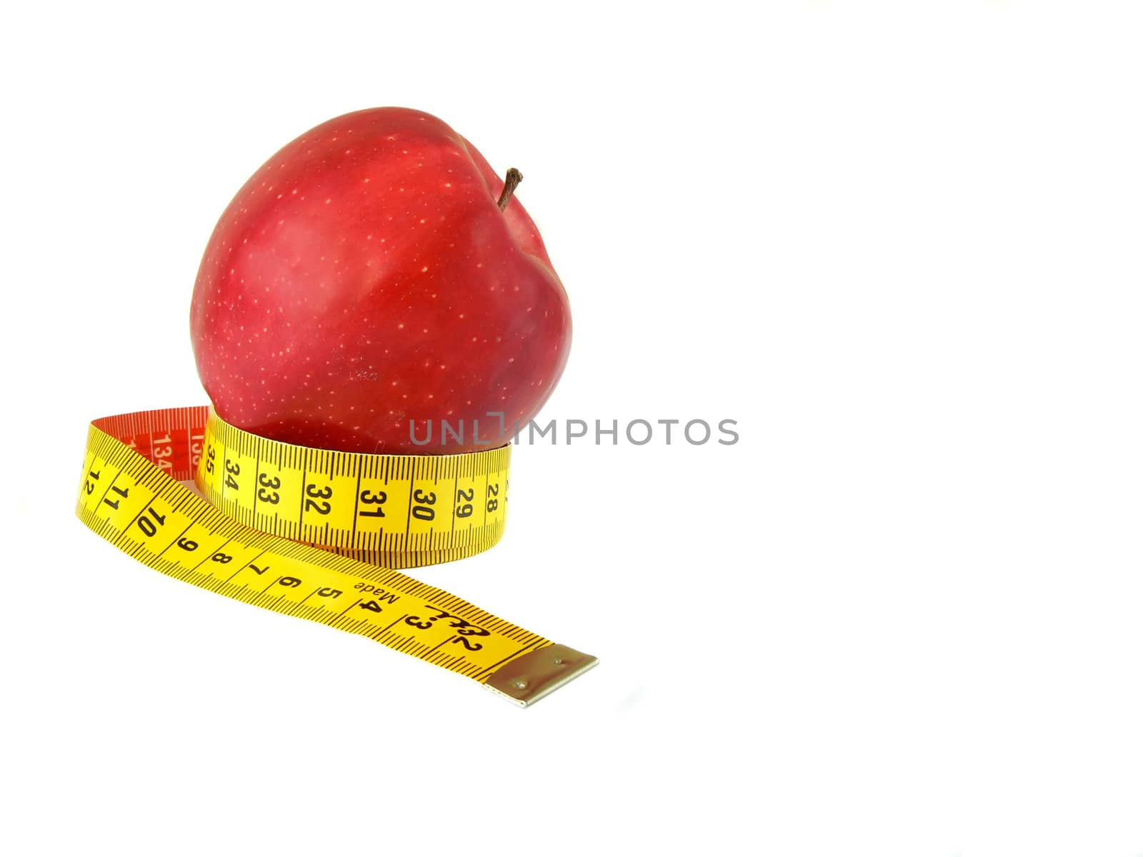 Red apple (malus) and measuring tape isolated on white