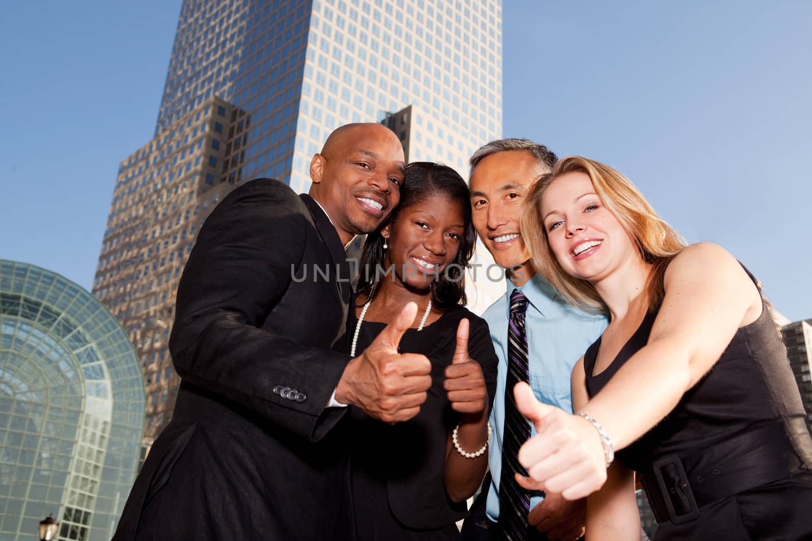 A group of business people giving a thumbs up sign