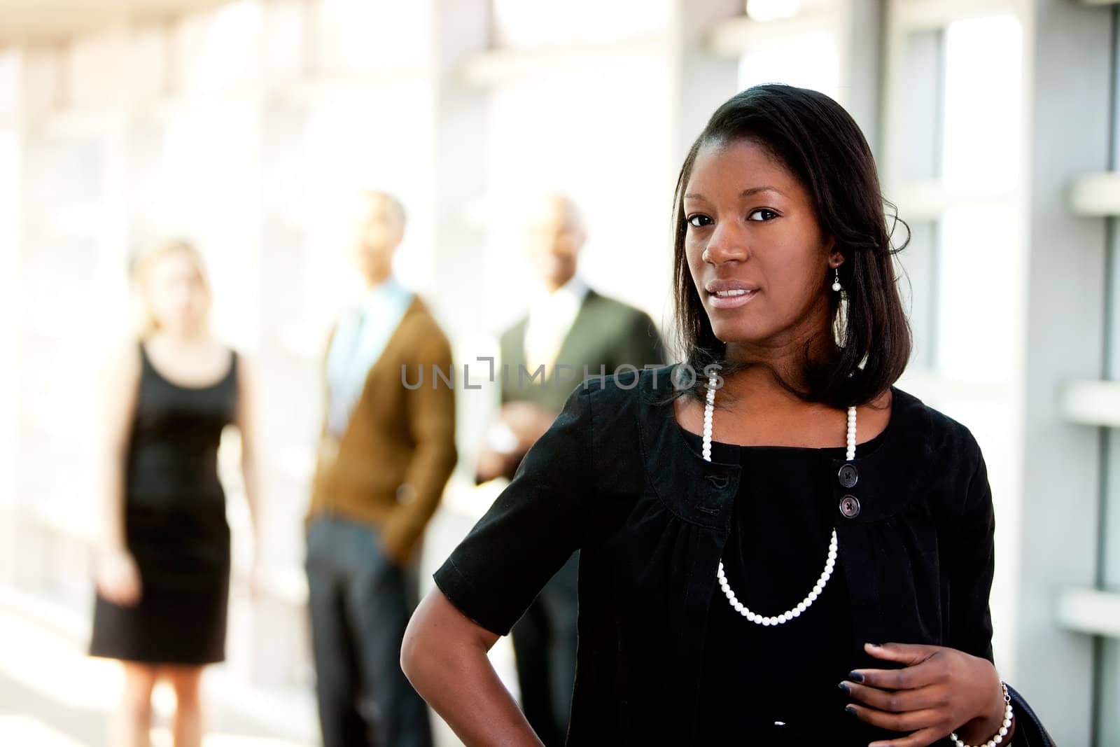An african american business woman with colleagues in the background