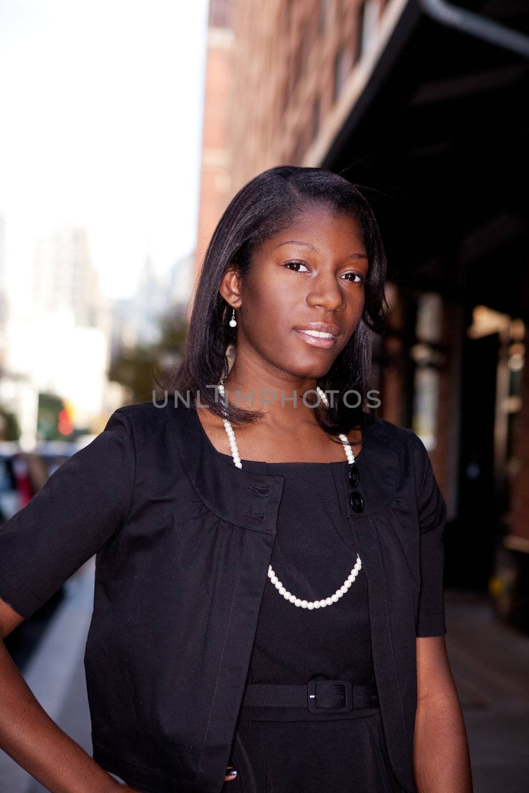 An African American business woman in an urban setting.