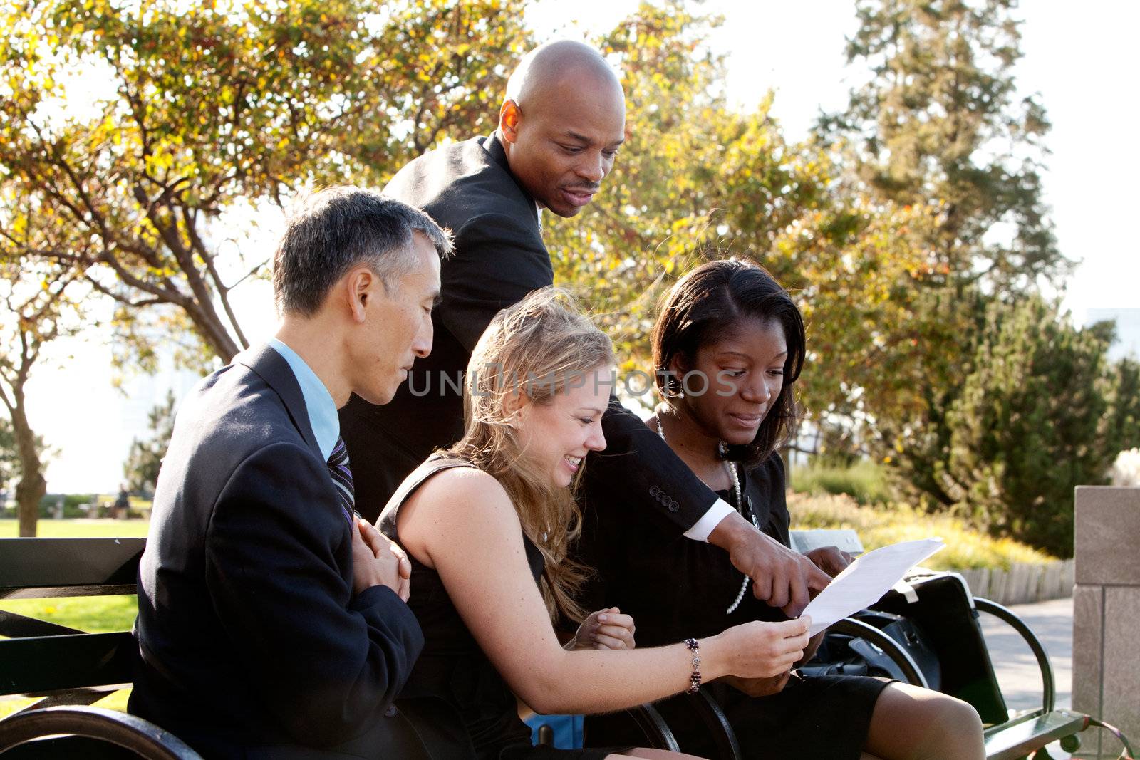 A group of business people in a park setting