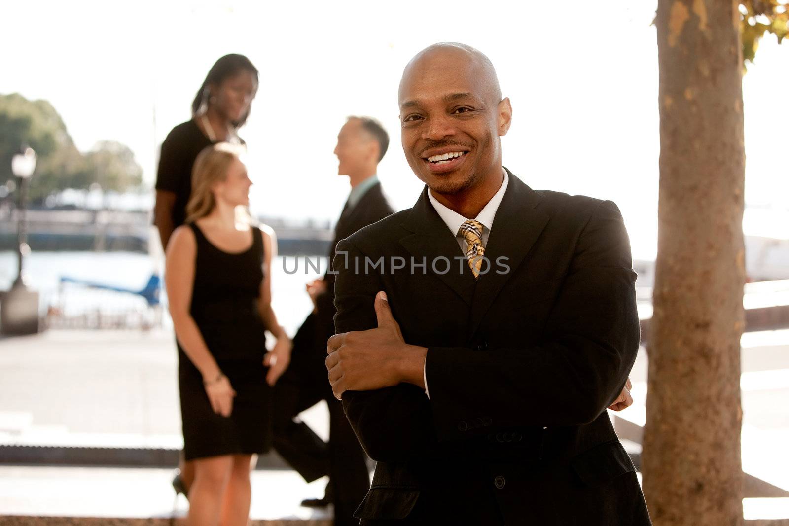 An african american business man with colleagues in the background
