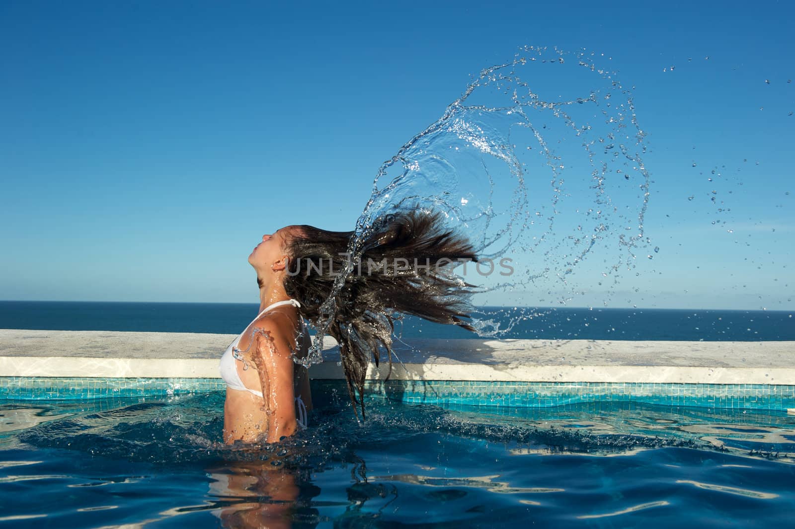 Woman relaxing in the spa swimming pool in Arraial d'Ajuda, Brazil