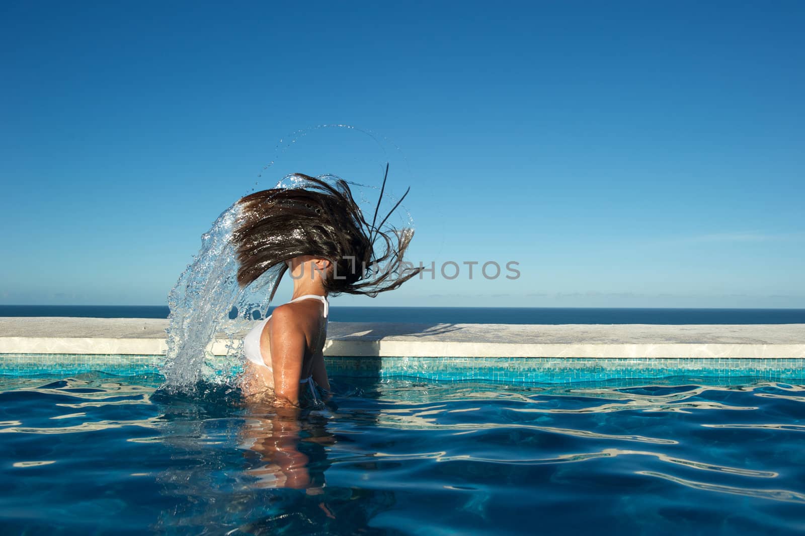 Woman relaxing in the spa swimming pool in Arraial d'Ajuda, Brazil