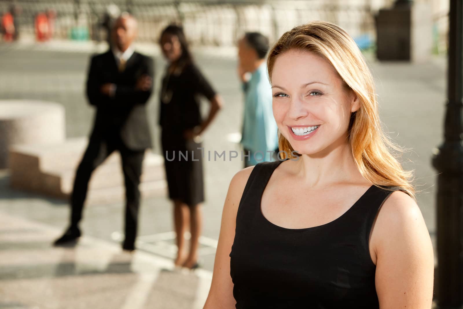 A business woman with colleagues in the background