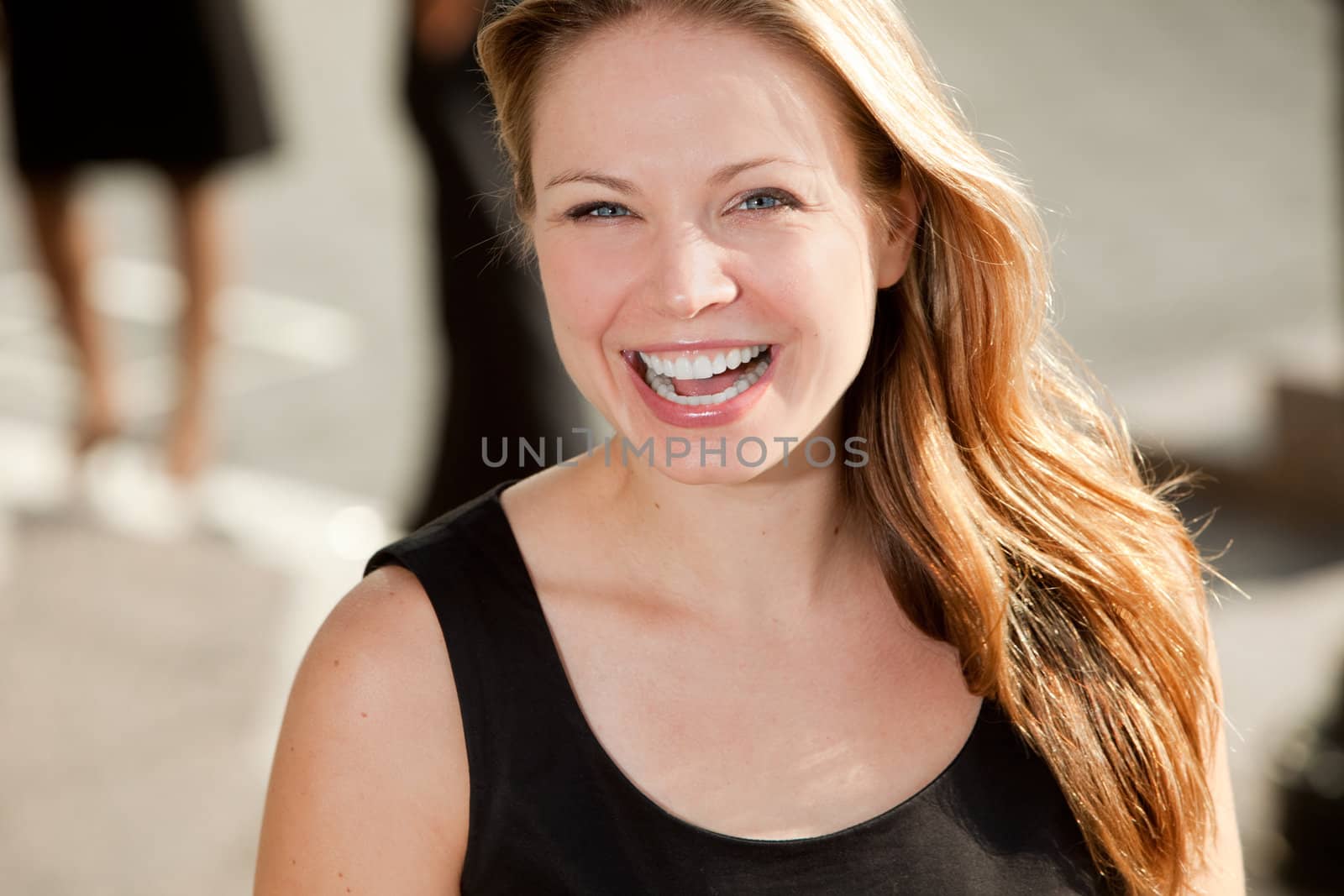 A portrait of a pretty blond woman with black dress