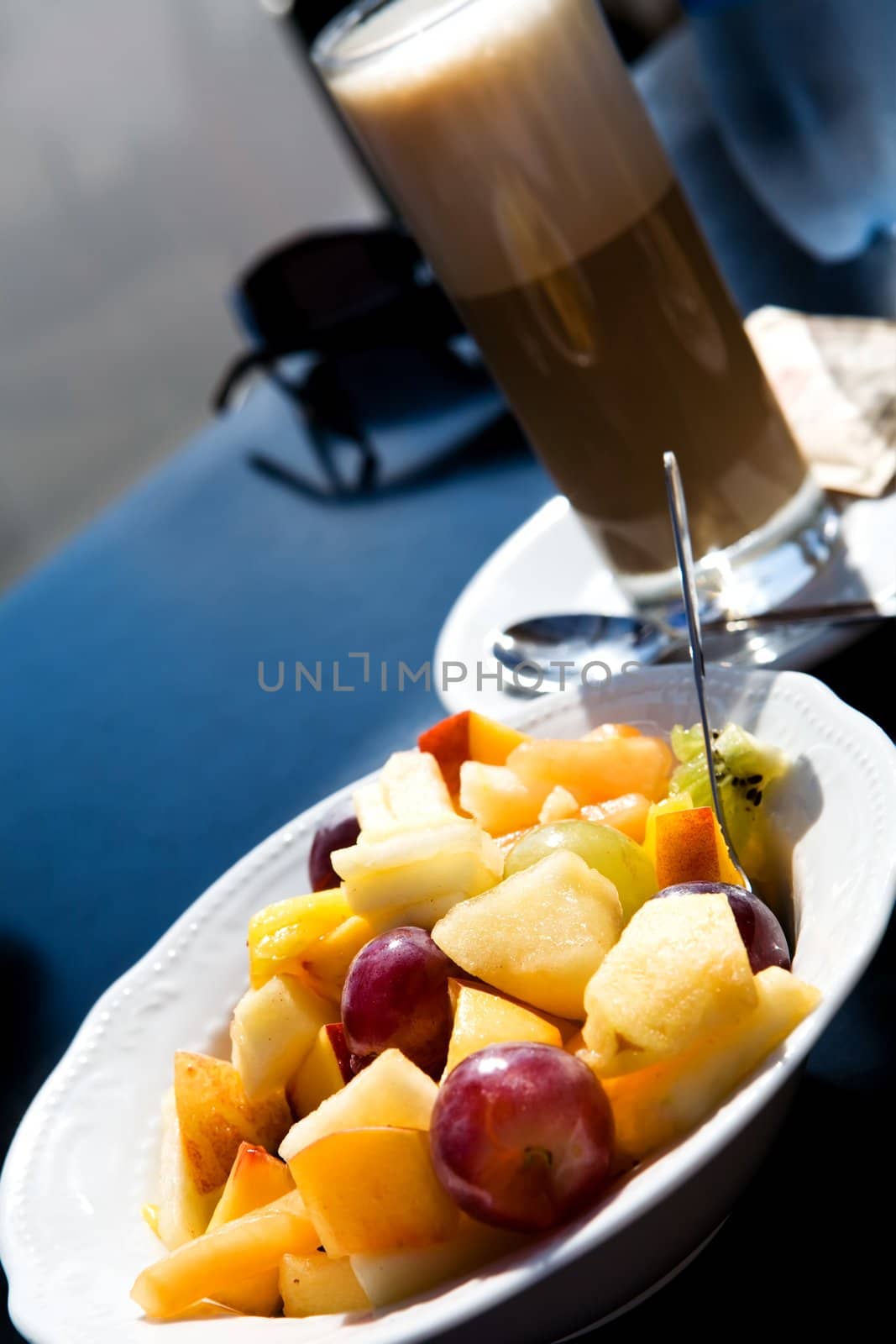 Fruit salad and coffee latte outdoors