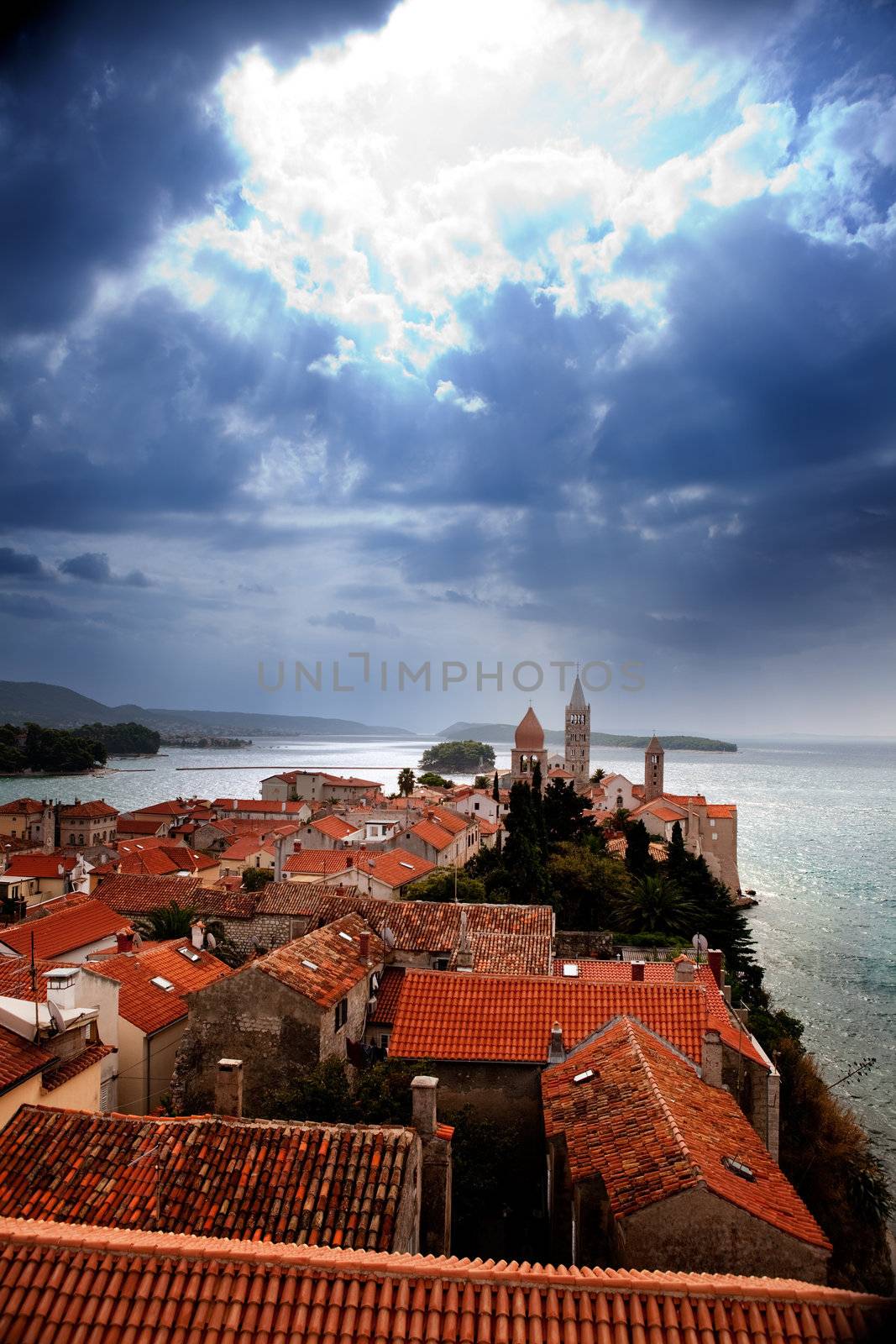 A medieval town with a dramatic storm filled sky