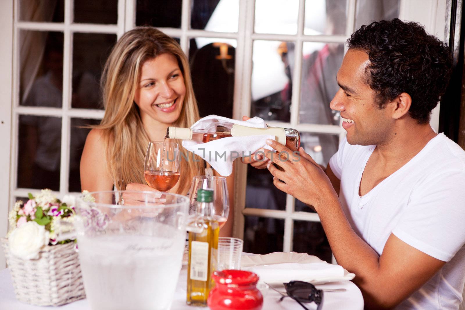 A happy couple on a date to an outdoor cafe; shallow DOF with focus on male