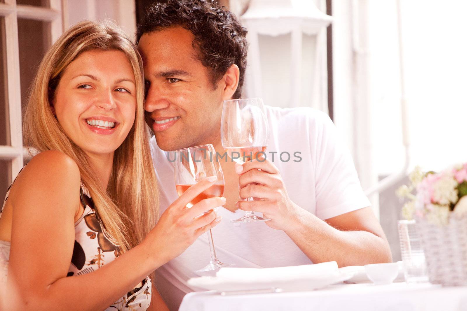 A happy couple in a outdoor restaurant on a date