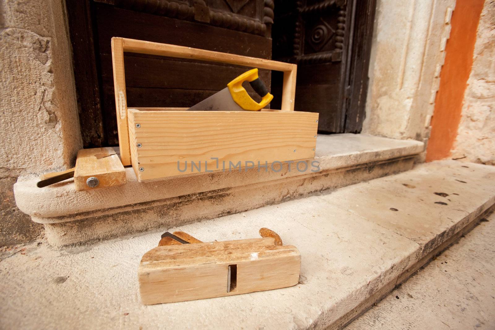 Old wood working tools on stone steps of a building