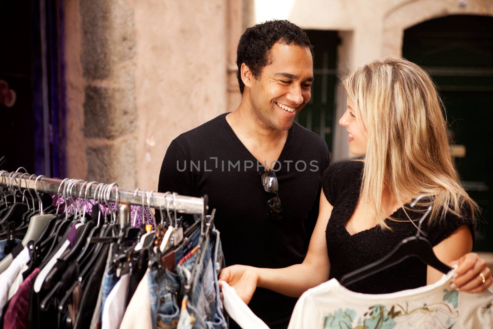 A happy couple shopping at a small street store in Europe