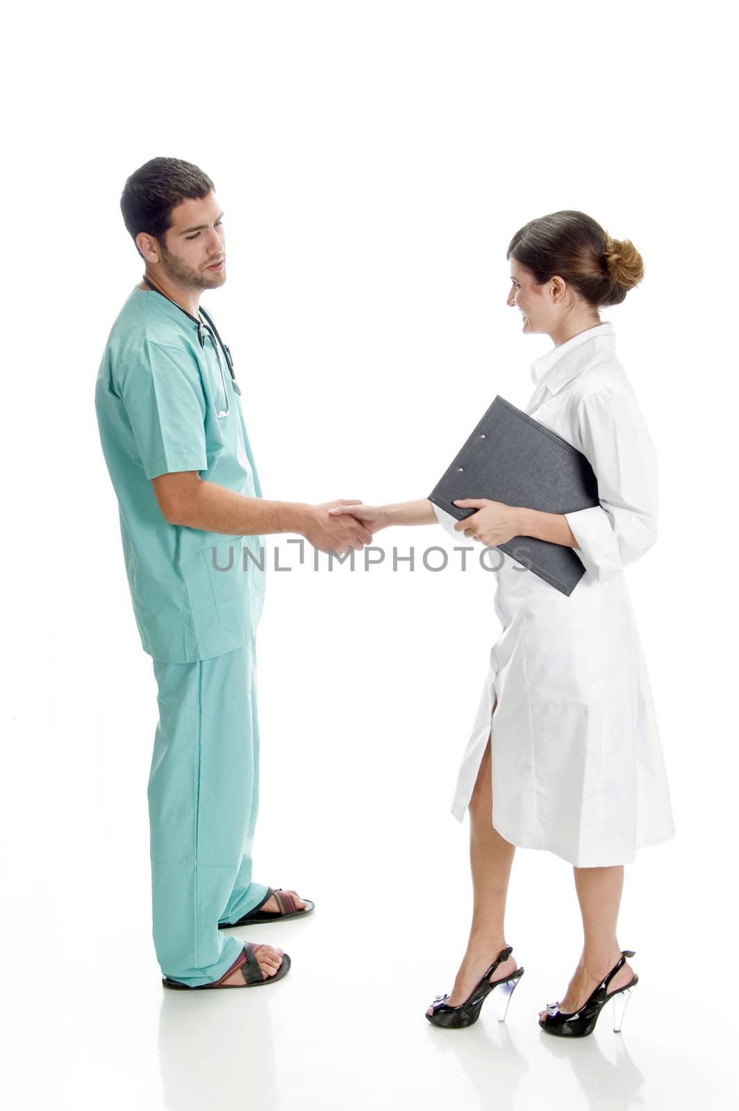 medical professionals shaking hands by imagerymajestic