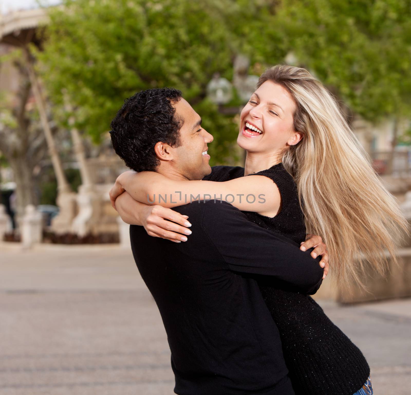 A happy playful couple in an urban setting