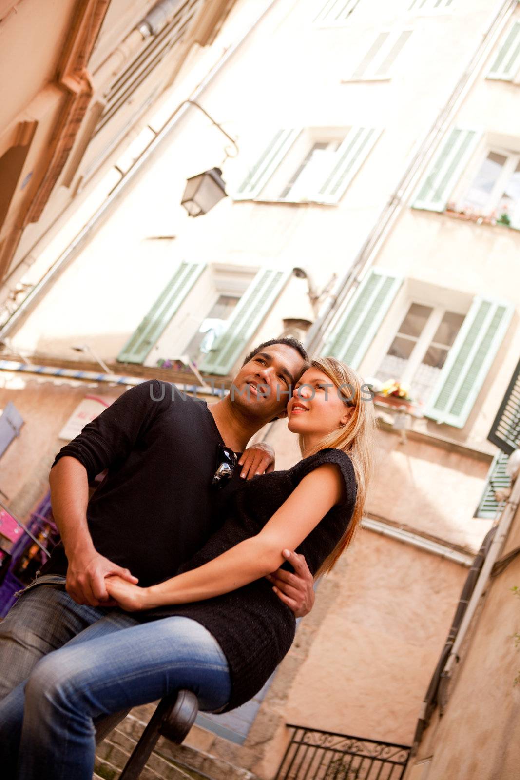 A happy french couple in a small quaint street