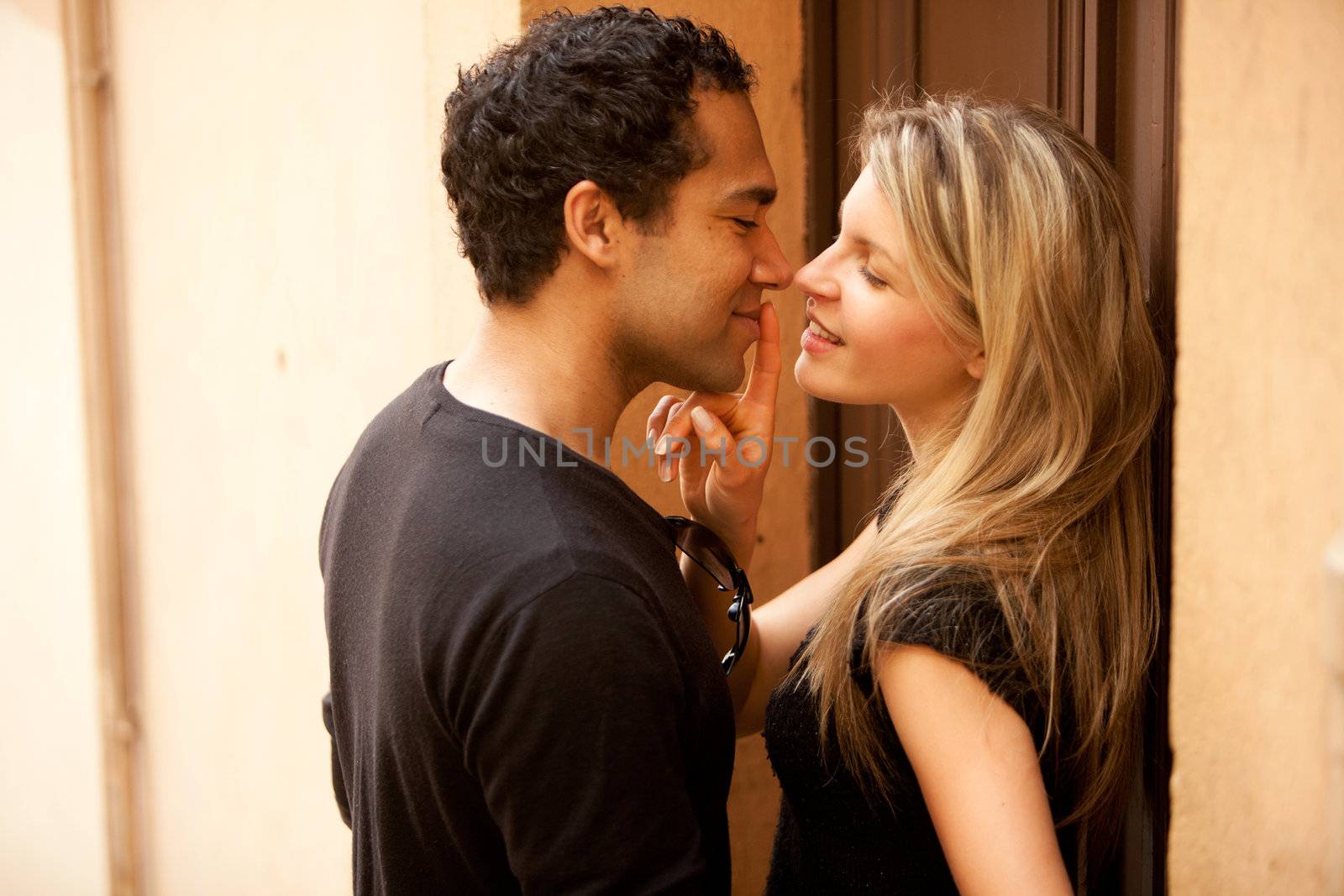 A couple flirting in an outdoor European urban setting