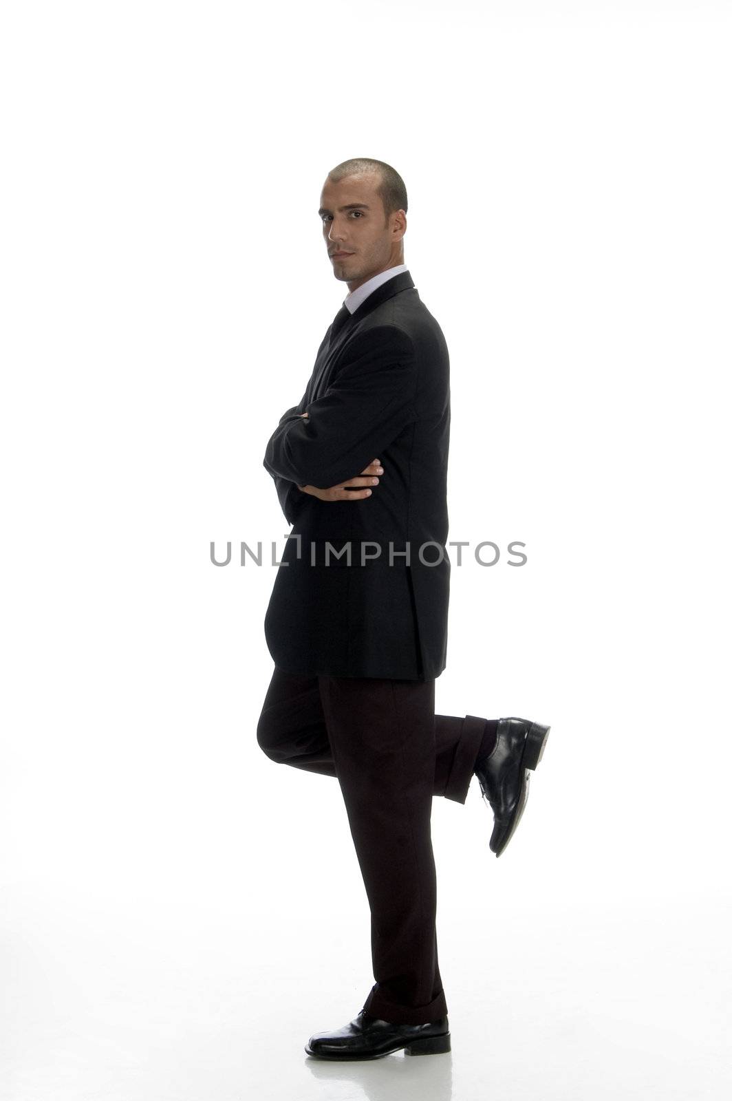 young businessman standing on one leg with white background