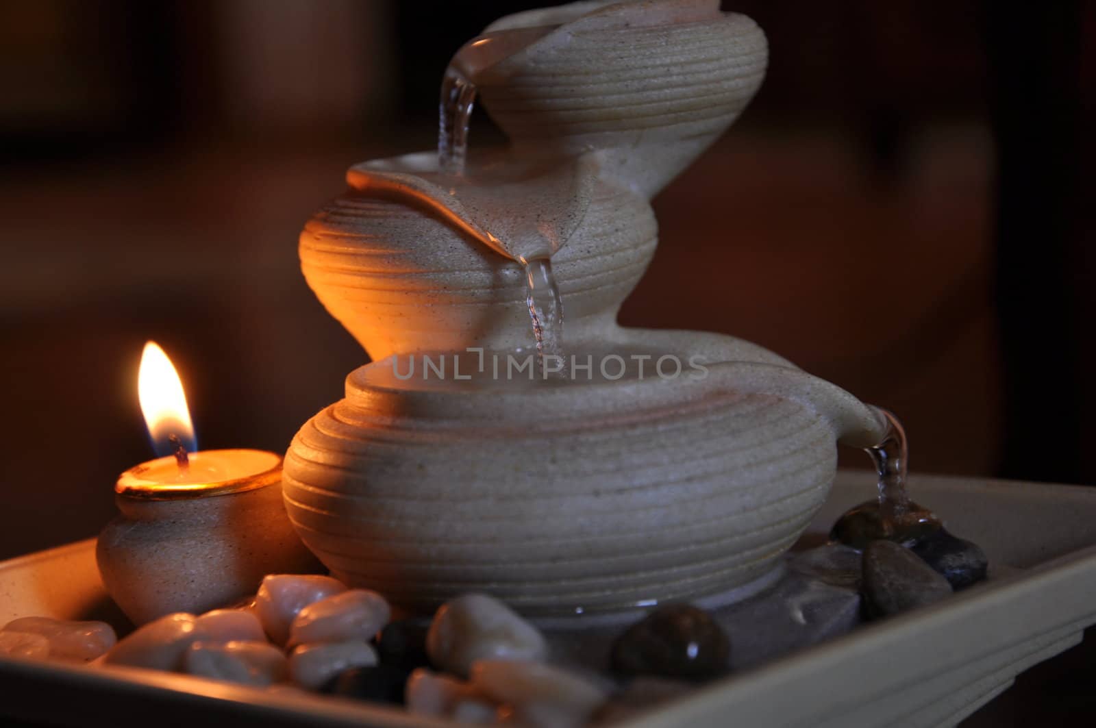 Mini fountain with burning candle in the livingroom