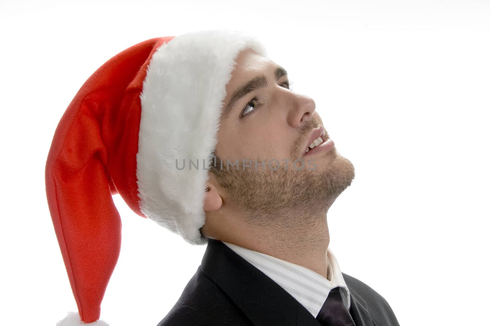 young man looking upside and wearing santa cap