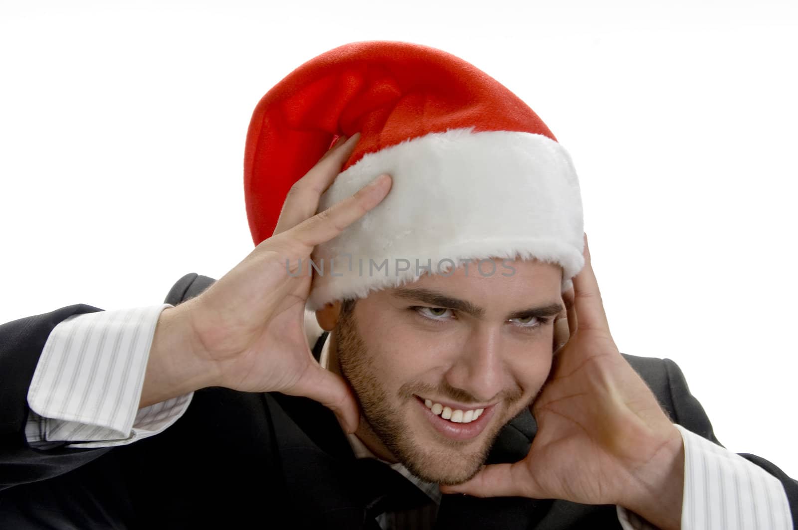 man posing with santa cap and holding his face on an isolated white background