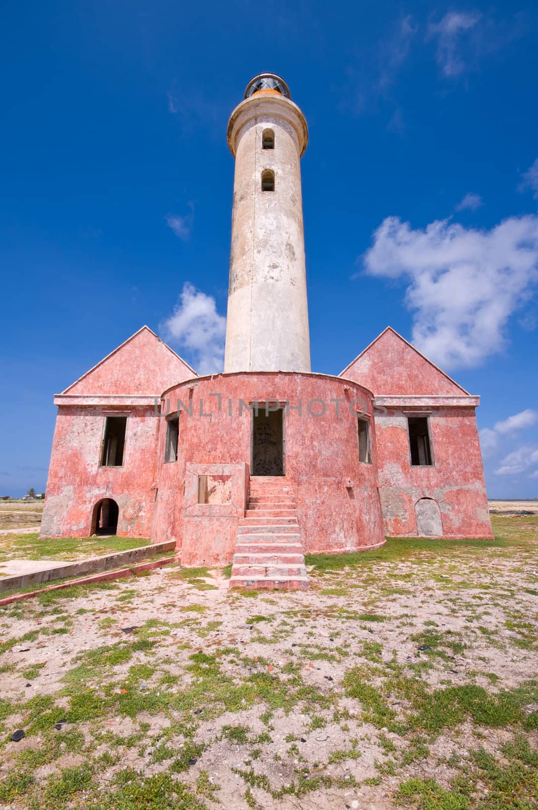 ancient lighthouse ruin on little curacao against blue cloudy sky