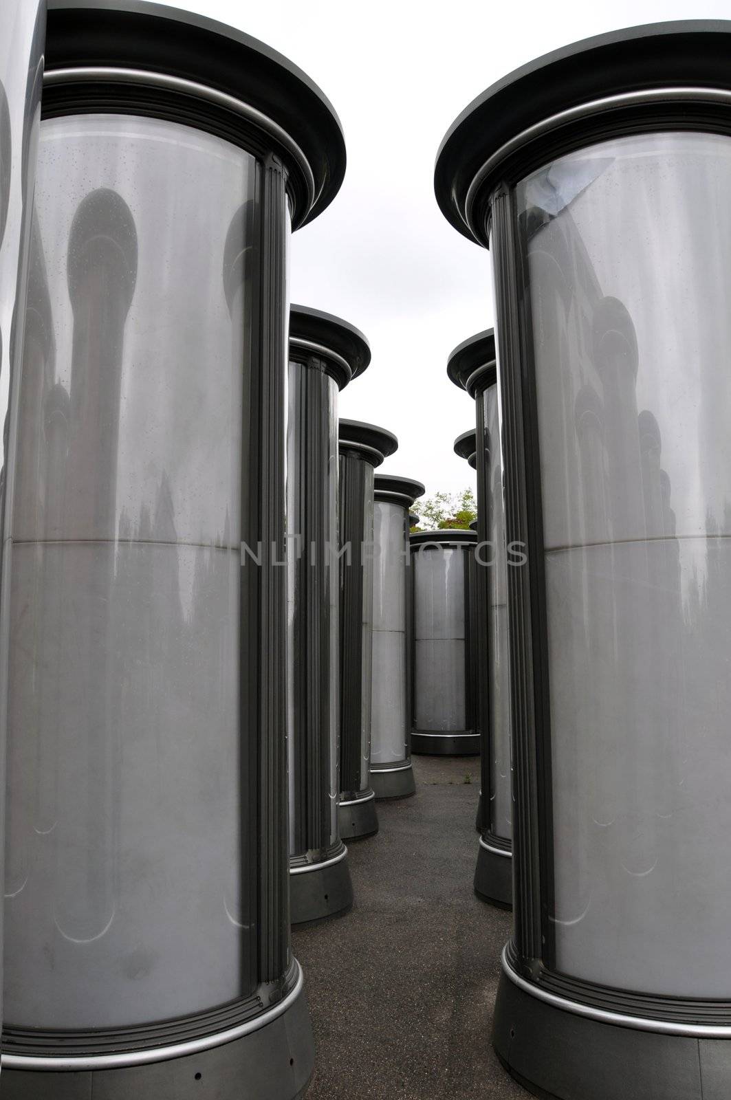 Rows of empty advertising columns stored in a backyard for later installation