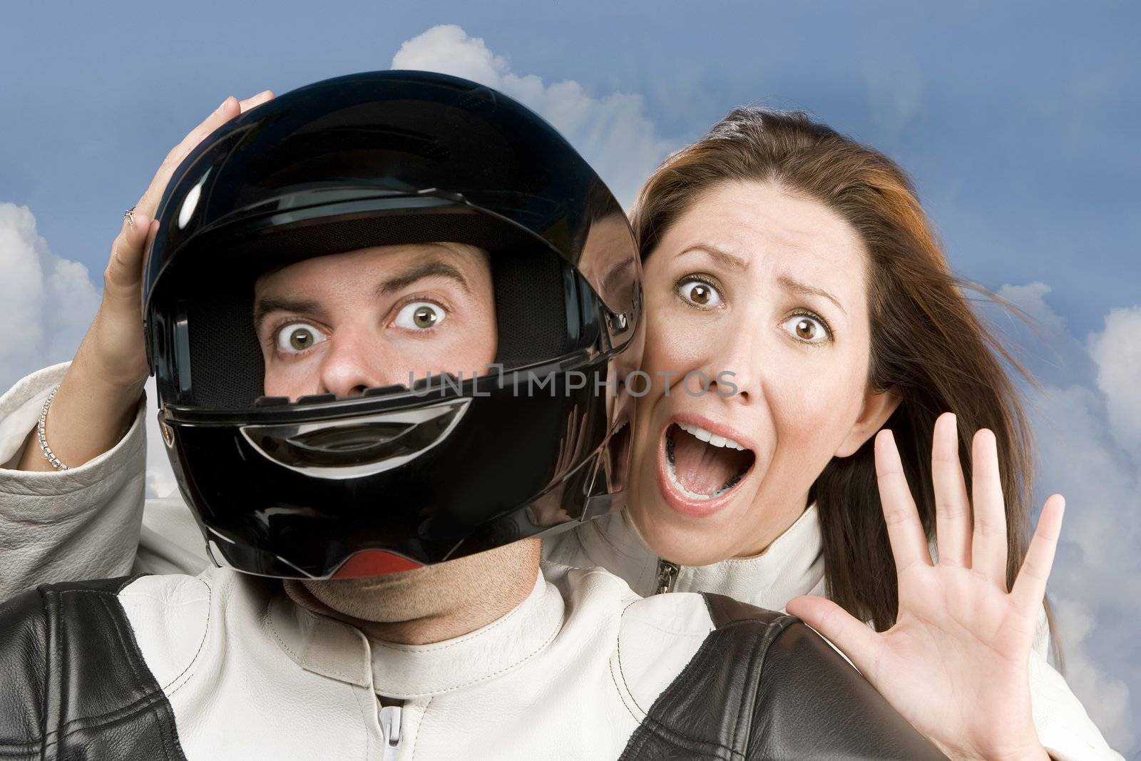 Man and fearful woman on a motorcycle in studio