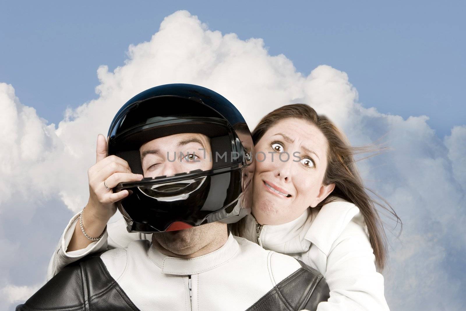 Man and fearful woman on a motorcycle in studio