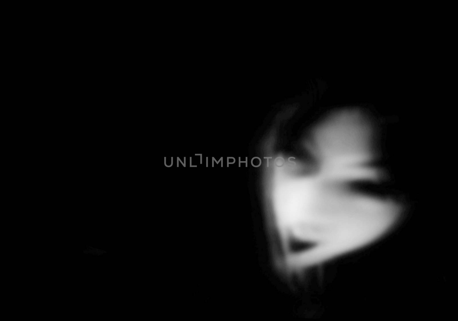 Ghostly figure on plain backdrop