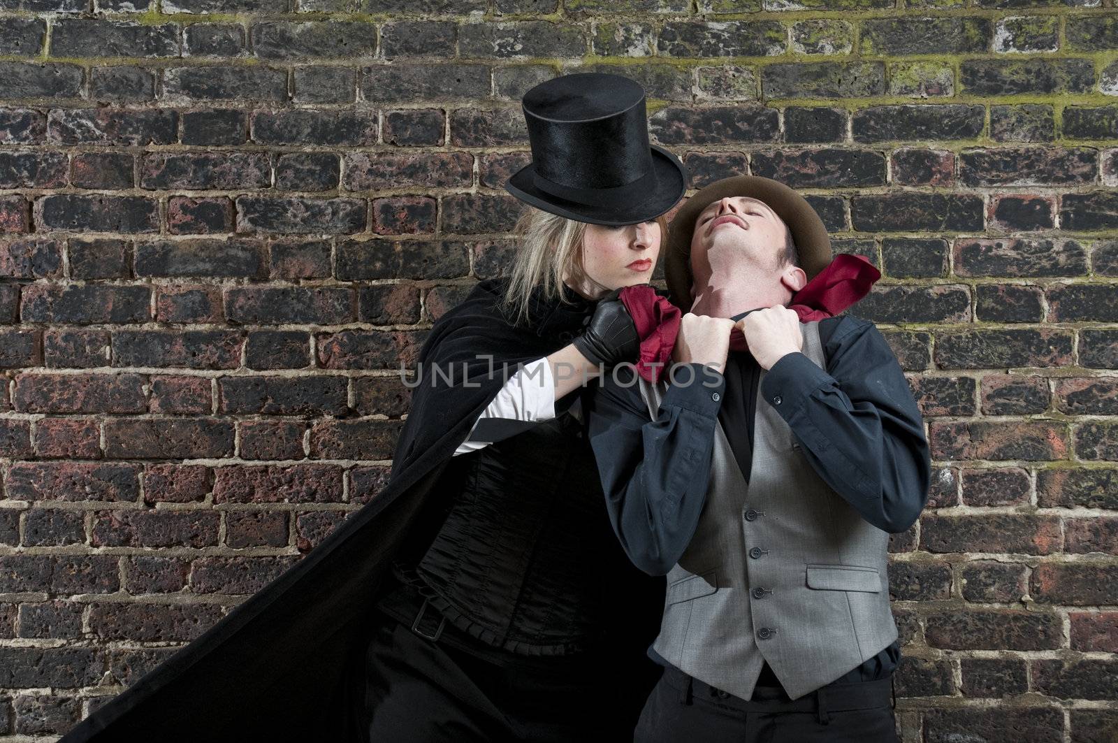 Fashion shot of woman  dressed as Jack the Ripper strangling man