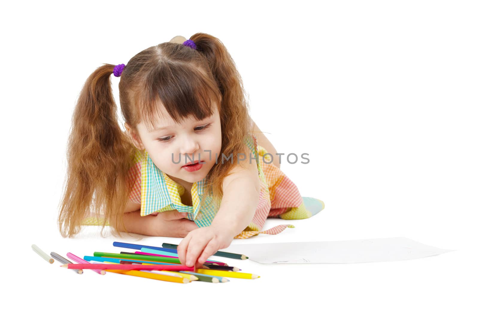 The child draws with color pencils on a white background