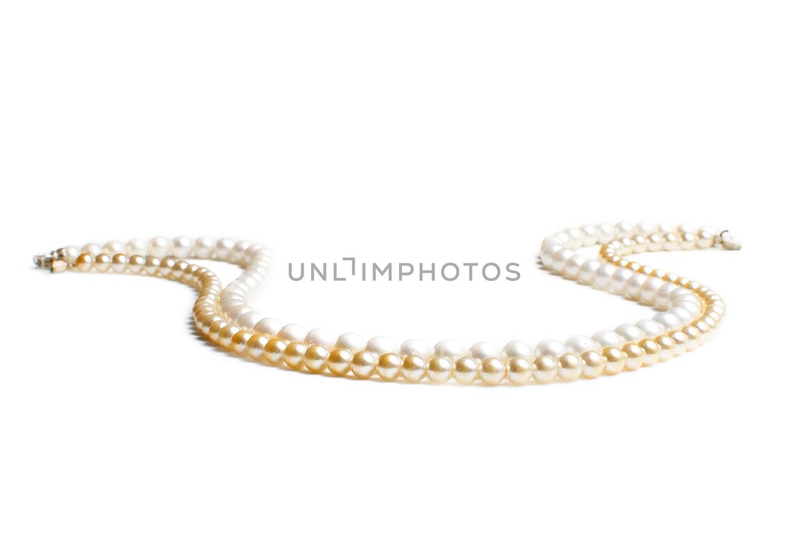Two necklaces of golden and white pearl beads isolated on white