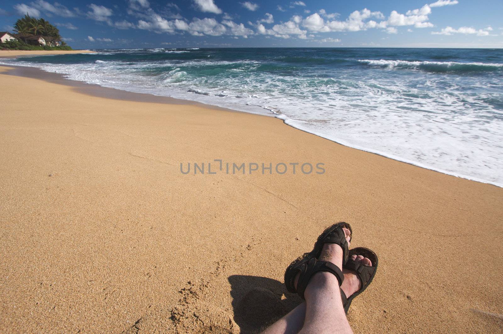 Man Relaxes on Tropical Shoreline on Kauai, Hawaii