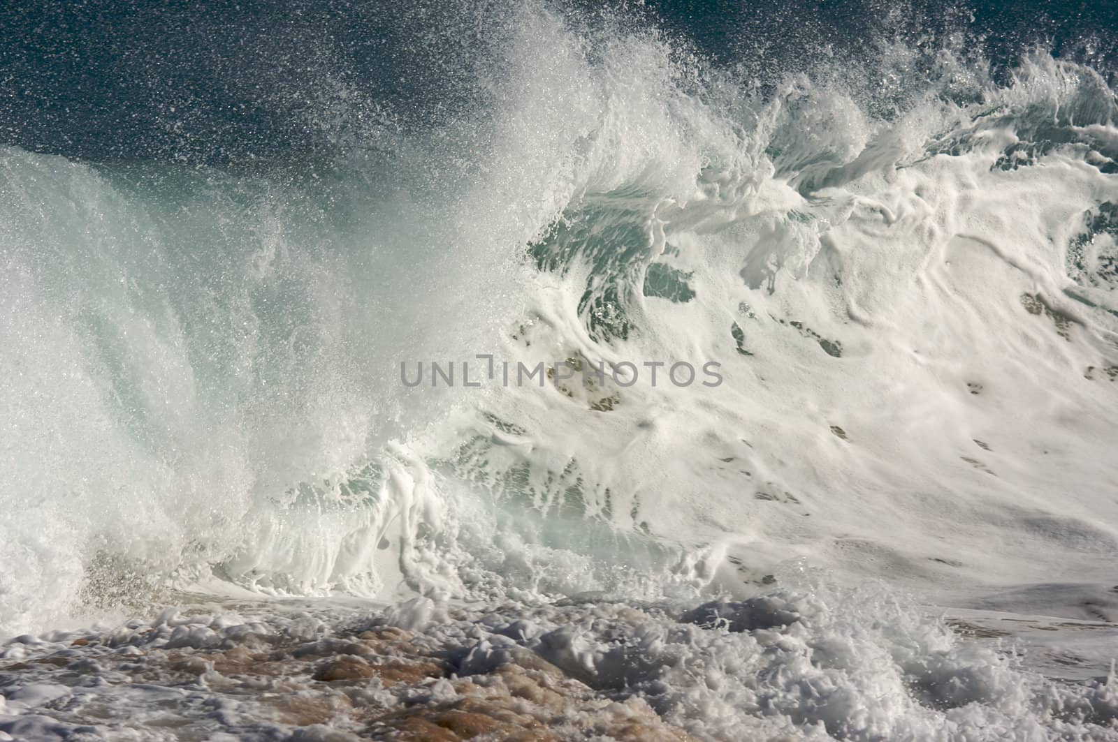 Dramatic Shorebreak Wave on a clear morning.