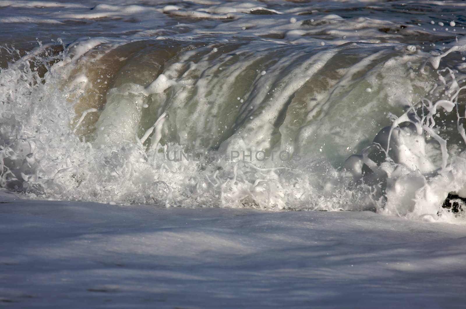 Dramatic Shorebreak Wave on a clear morning.