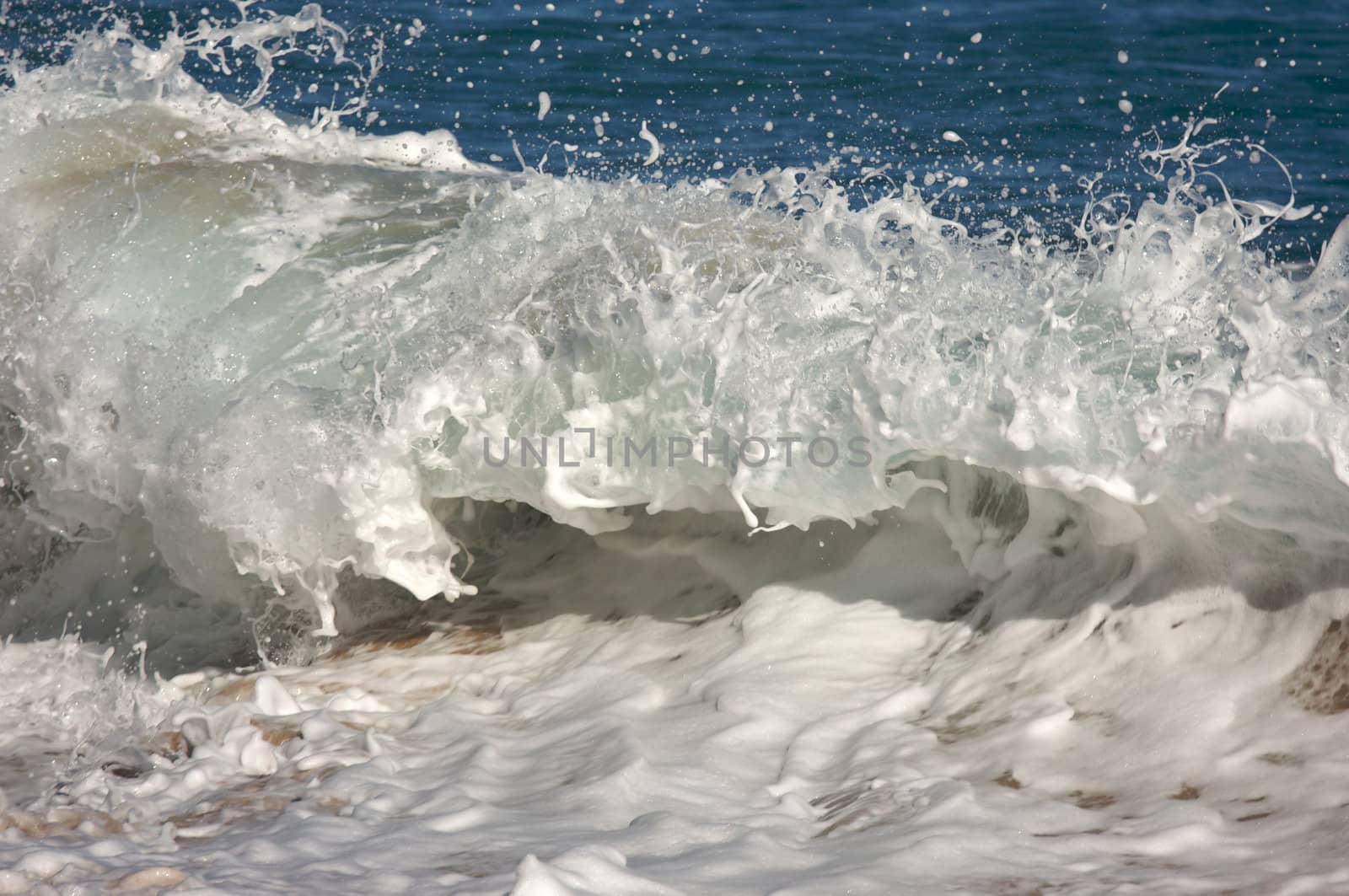 Dramatic Shorebreak Wave on a clear morning.