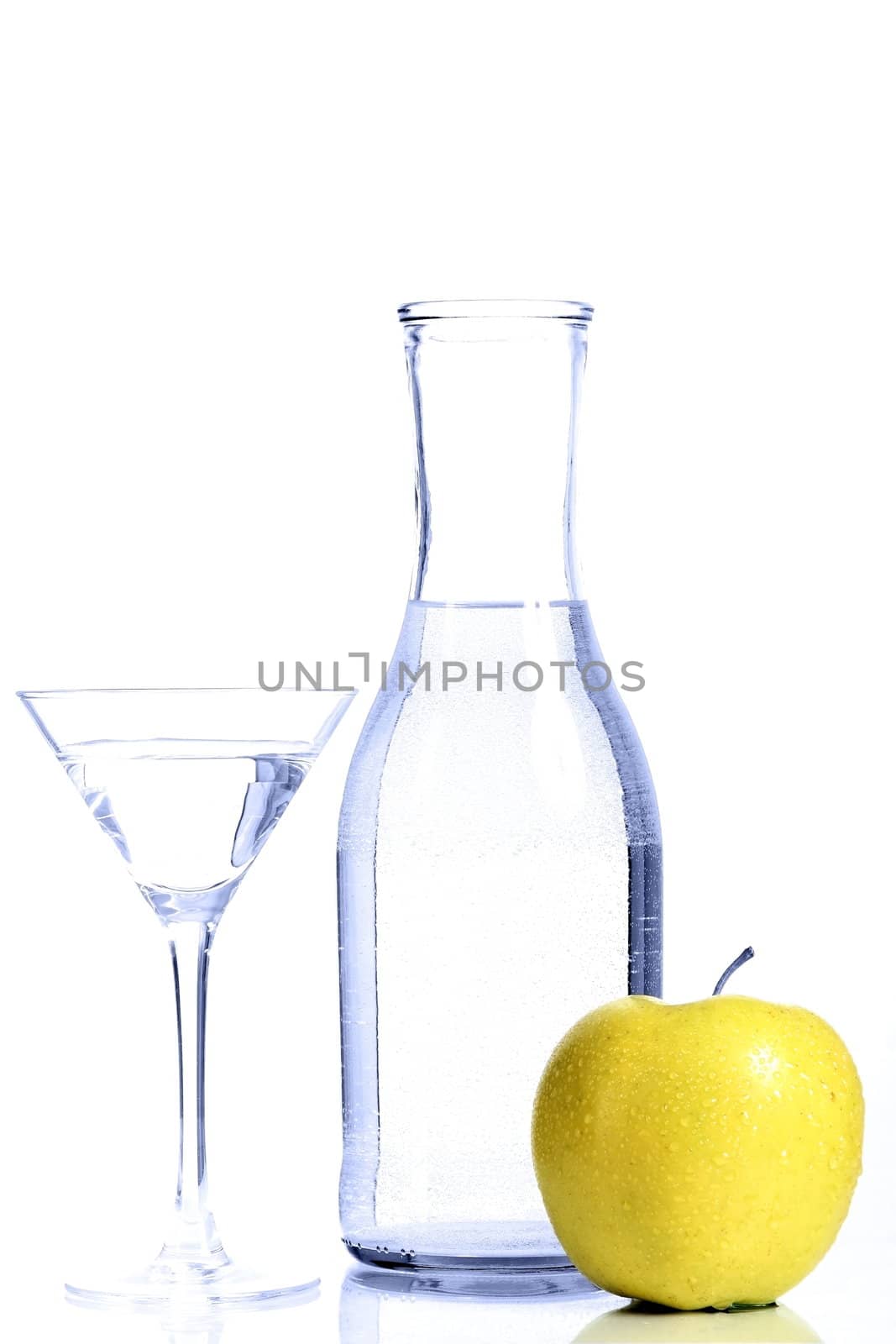 Bottle with transparent water, a glass and apples on a white background