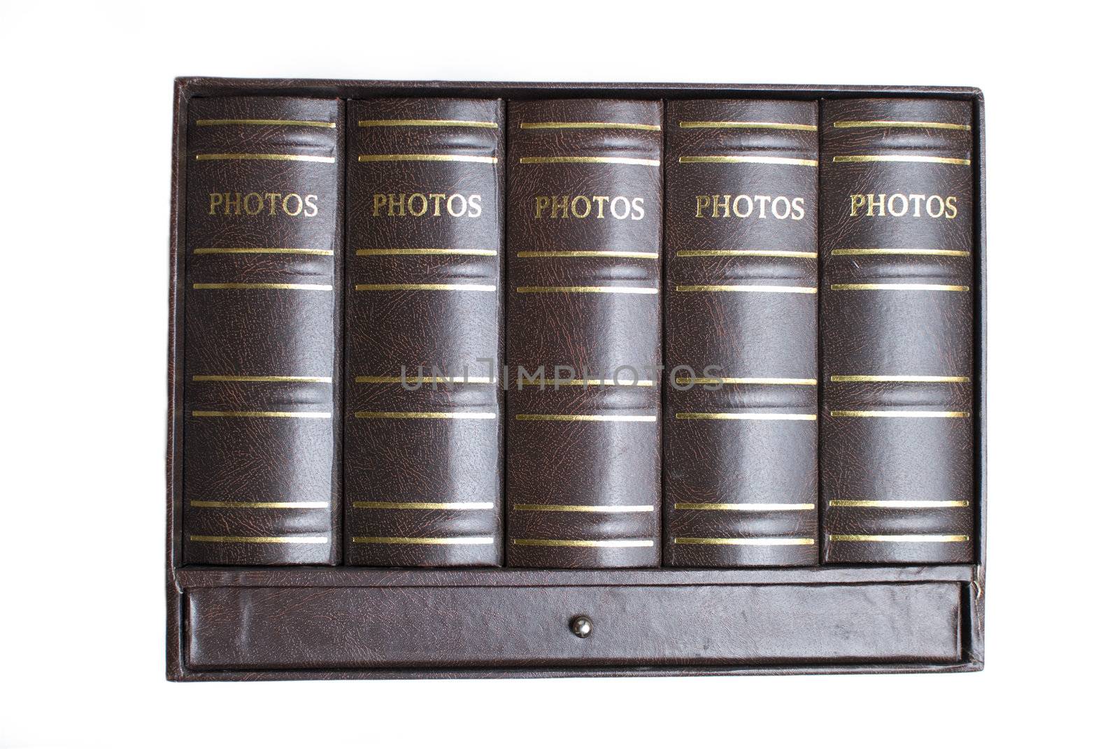 Five photo books in mini bookcase isolated on white background (front view)