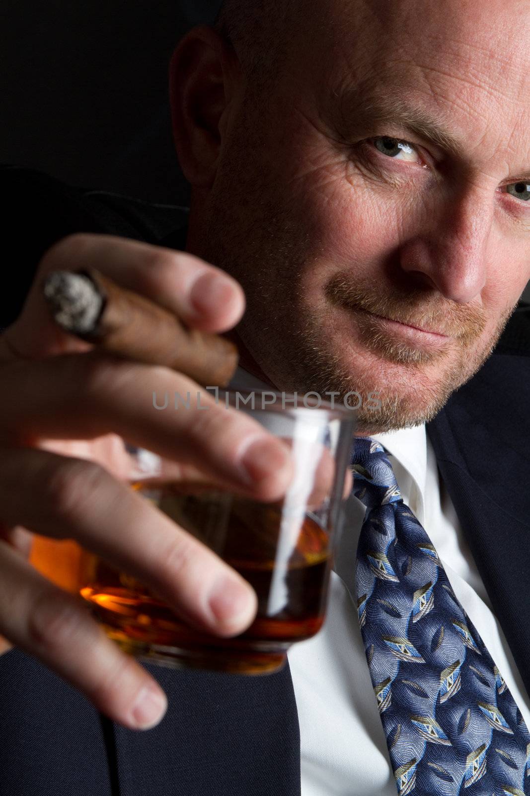 Businessman drinking and smoking cigar