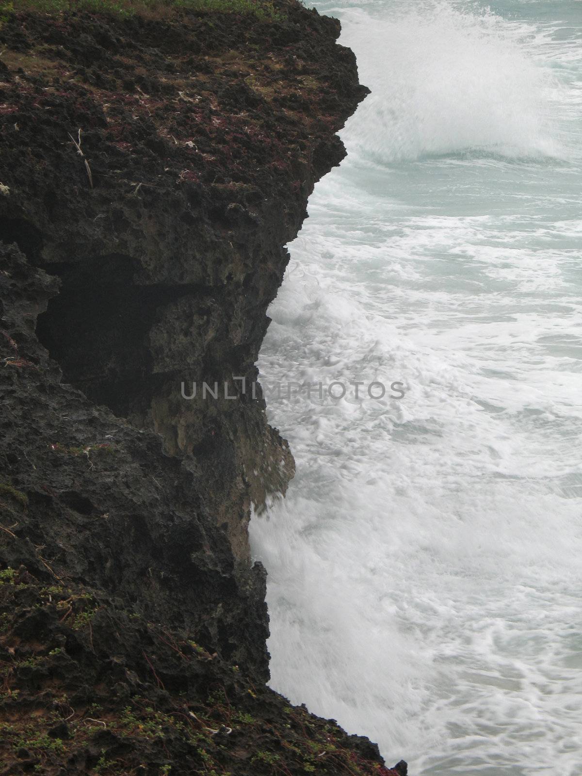 cliff and angry ocean water